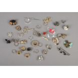 A quantity of costume jewellery rings, pins and brooches.