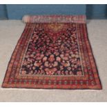 A large blue ground Persian Suruk runner featuring all over floral pattern. 357cm x 127cm.
