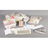 A collection of loose stamps including international examples and presentation packs.