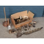 A box of metalwares. Including chandeliers, goblets, horse brasses, etc.