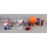 A collection of art and cranberry glass to include animals, baskets, paperweights, etc.