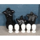 Three mannequin torsos along with several polystyrene heads.