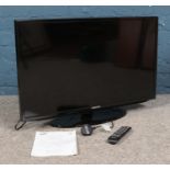 A Samsung 32" UE32EH5000 TV, with remote and instruction booklet.