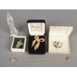 A Swarovski grape brooch and pendant necklace, together with two boxed Napier brooches and a crystal