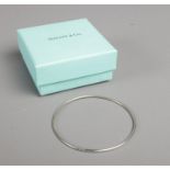 A boxed Tiffany and Co. silver bangle, marked to band and stamped 925. Weight: 5.5g Slight