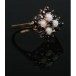 A 9ct Gold Opal and Sapphire cluster ring set in diamond form. Size JÂ½. Total weight: 2.5g