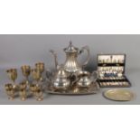 A quantity of metalwares, including cased flatware set, serving trays and large teapot. Hinge