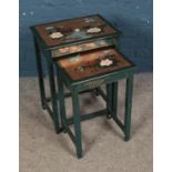 An oriental themed set of nesting tables featuring painted floral scene.