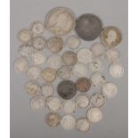 A quantity of silver pre 1920s coins. Includes 1887 Victorian gothic florin, etc. 78g