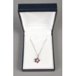 A 14ct White Gold Ruby and Diamond floral pendant on 9ct White Gold chain. Total weight: 3.8g.
