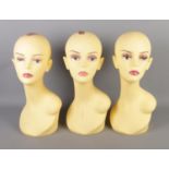 Three mannequin heads.