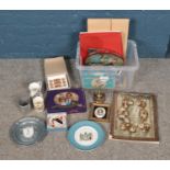 A collection of Royal memorabilia to include Wedgwood, commemorative tins, stamps, thimbles, etc.
