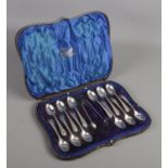 A Victorian cased set of twelve coffee spoons and a pair of sugar tongs. Assayed Sheffield 1897 by