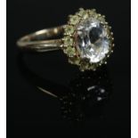 A 9ct Gold topaz and tsavorite garnet halo ring. Size N. Total weight: 3.9g