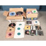 Two boxes of singles and records including pop and classical examples.