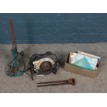 A box of tools including circular saw, tongs, box of measuring tools, etc.