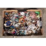 A large tray of costume jewellery, including necklaces, earrings, bangles etc.