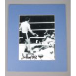 Sir Henry Cooper; a signed monochrome photograph showing the knockout against Muhammad Ali. Signed