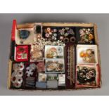 A tray of assorted costume jewellery, to include enamel pin badges, necklaces, boxed rings, and