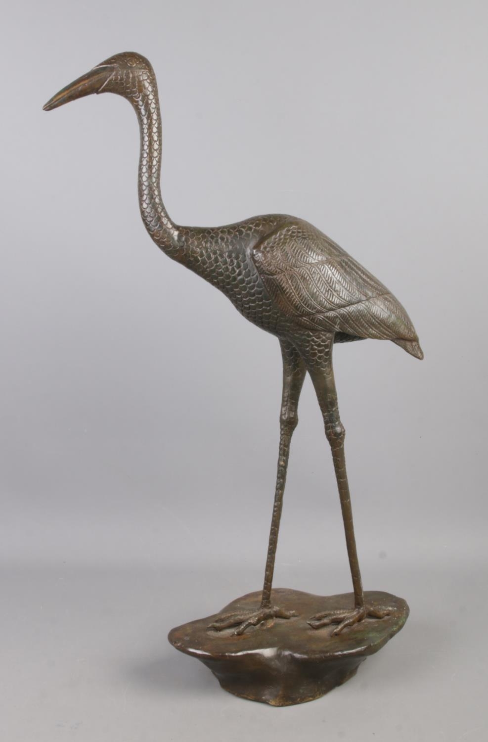 A bronze figure of a crane. 64cm high.