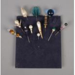 A quantity of vintage hat pins including simulated pearl and gemstone examples.