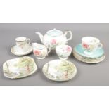 A collection of bone china teawares. Includes Aynsley, Shelley Woodland pattern and Royal Doulton