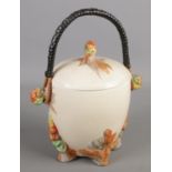 A Newport Pottery Clarice Cliff lidded barrel. With swing handle. (20cm) Chip to lid.
