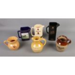A collection of advertising water jugs including Johnnie Walker's Black Label, Jameson, Riding