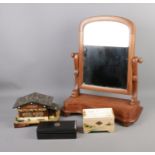 An assortment of decorative boxes along with toilet mirror.