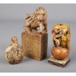 Three Chinese items. Includes carved bone snuff bottle, hardstone mythical beast on plinth and a