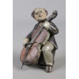 A cold painted spelter figure of a celloist. 8.5cm tall. Paint scratched in some areas.