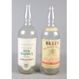 Two large alcohol bottles. Includes Bell's Whisky and Christopher's London Gin.