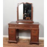 A stained oak dressing table with mirror. Featuring drawers to each side and scalloped knee hole,