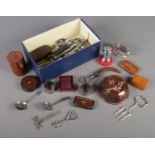 A box of collectables and metalwares. Includes butterfly paperclip, spoons, boxes, Ronson lighter,