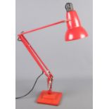 A Herbert Terry red angle poise lamp.