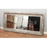 A large modern bevel edge floor mirror featuring silver coloured floral frame. Approx. dimensions