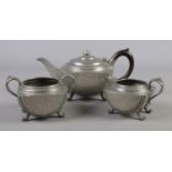 A three piece Sheffield hammered pewter tea set.