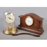 An inlaid mahogany Buren mantel clock, along with a TimeMaster torsion clock with glass dome.