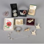 A tin of costume jewellery mainly consisting of brooches include Corgi, 'Exquisite' Poppy, screw