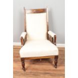 A mahogany cream upholstered arm chair on castors.