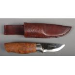 A Norwegian Brusletto hunting/bush craft knife. With walnut grip, silver collar and leather sheath.