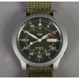 A Gentleman's Seiko 5 automatic wristwatch. With green dial and strap. Running.