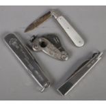 A small quantity of silver. Includes silver handled cigar cutter, silver handle pocket knives, etc.