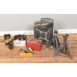 A collection of metal wares comprising of oil cans, axle stands and several spare car parts.