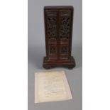 A small Chinese family memorial shrine with pierced door decoration. Containing boards of