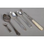 A small quantity of silver. Includes silver spoons, silver pickle fork with mother of pearl