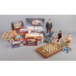 A collection of assorted items, to include backgammon board, boxed diecast cars and action man
