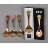 Four Georg Jensen silver gilt year spoons featuring floral enamel decoration. Includes years 1974,