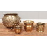 Four brass planters, including large example featuring grape decoration, lion mask handles and paw