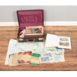 A suitcase containing an assortment of postcards and vintage ordinance survey maps including 4:1